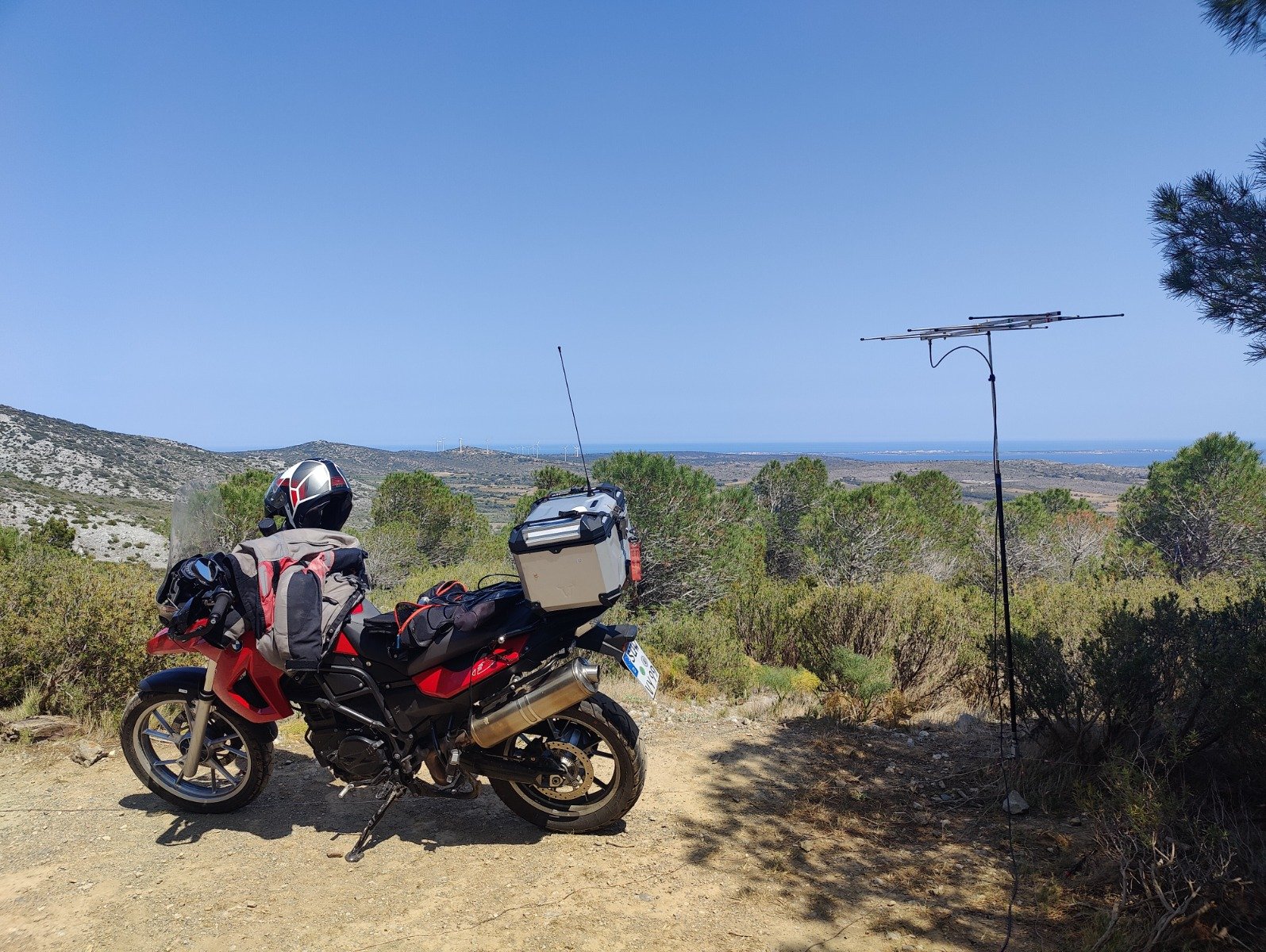 Motorrad und Antennen vor Berglandschaft